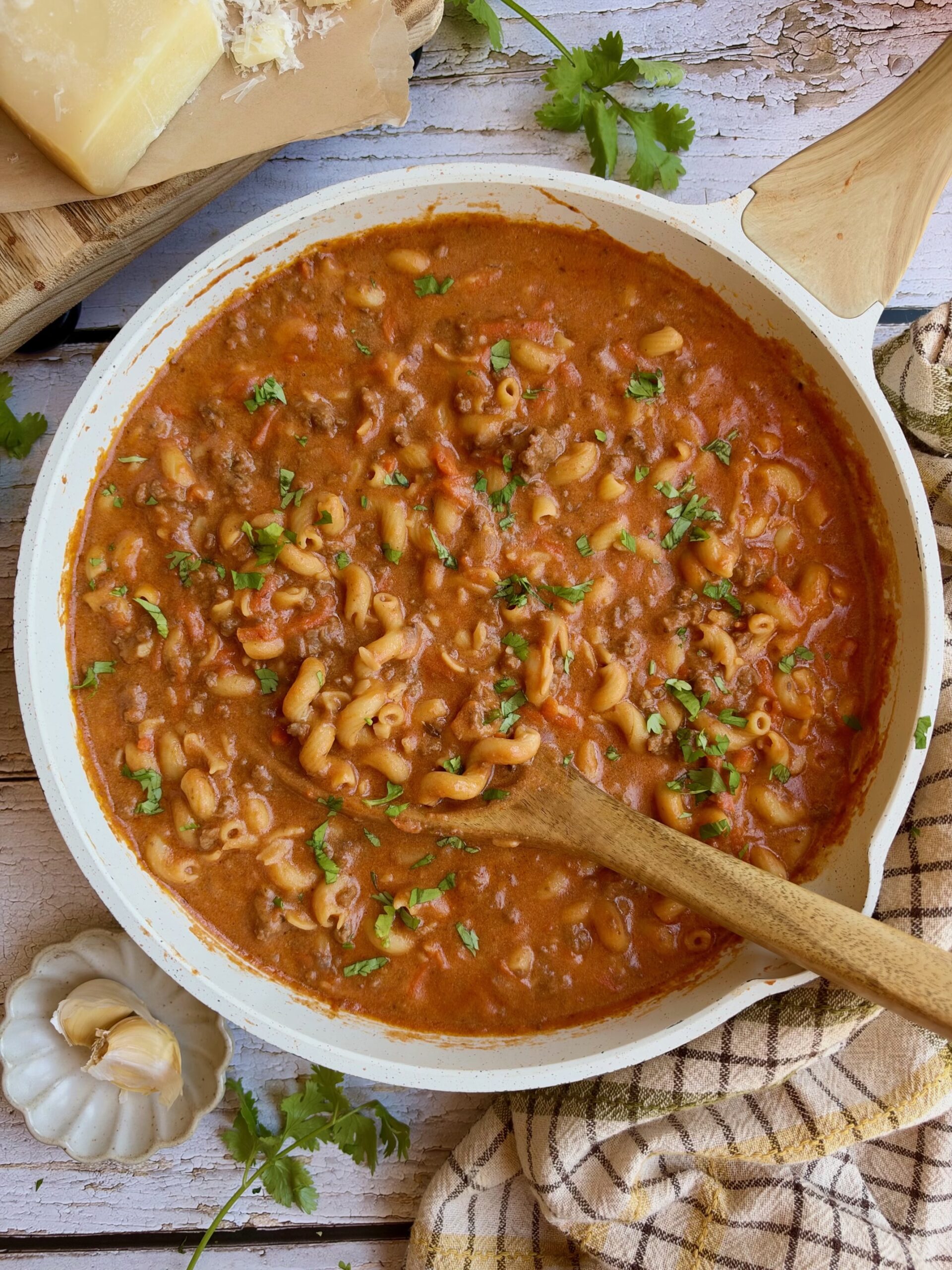 One skillet cottage cheese pasta with ground beef in a creamy tomato sauce, garnished with parsley.